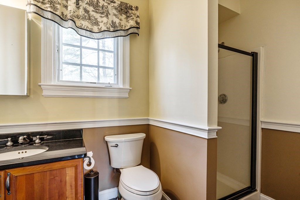 50 Corn Road Bolton, MA 01740 - Photo 31 of 40 a bathroom with a toilet a sink and a window