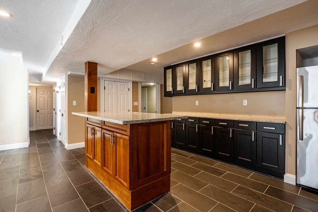 50 Corn Road Bolton, MA 01740 - Photo 33 of 40 a kitchen with stainless steel appliances granite countertop a stove and a sink