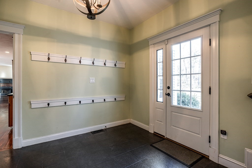50 Corn Road Bolton, MA 01740 - Photo 36 of 40 an empty room with wooden floor and windows