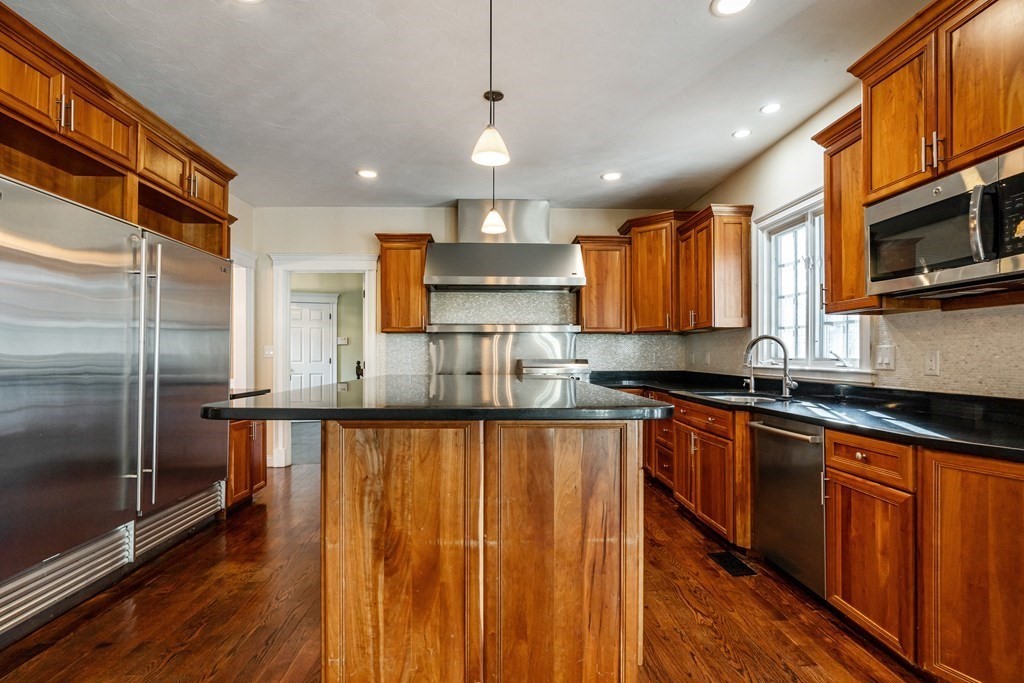 50 Corn Road Bolton, MA 01740 - Photo 4 of 40 a large kitchen with stainless steel appliances granite countertop a refrigerator a sink dishwasher a stove and a microwave oven on granite countertops