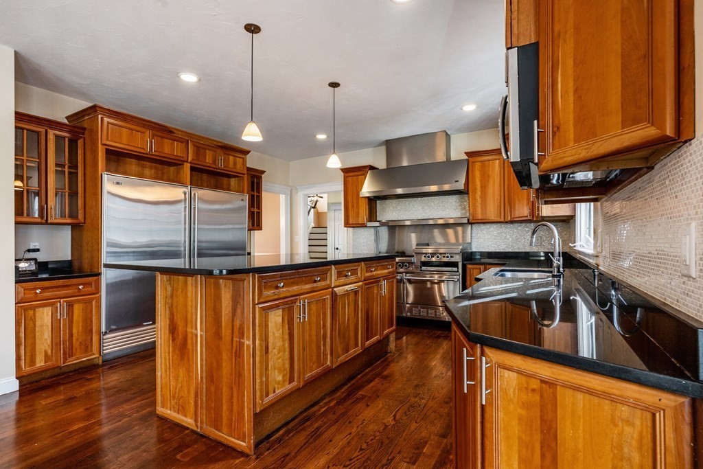 50 Corn Road Bolton, MA 01740 - Photo 5 of 40 a kitchen with stainless steel appliances granite countertop a sink a stove and a wooden floors