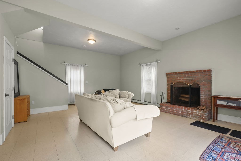 94 Fearing Hill Road Wareham, MA 02576 - Photo 6 of 41 a living room with furniture and a fireplace