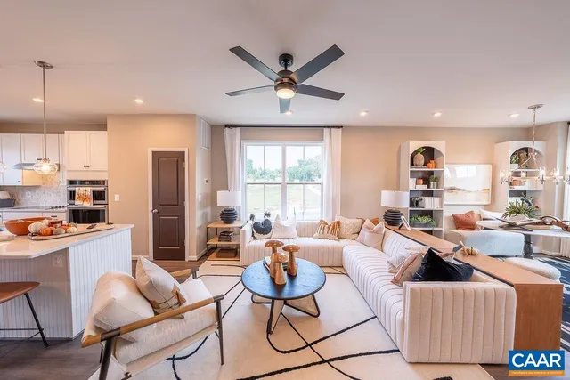 a living room with furniture a window and a chandelier