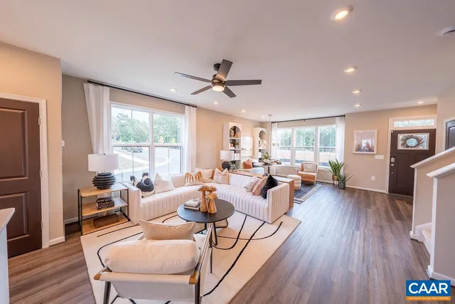 a living room with furniture or wooden floor and a large window