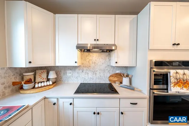 a kitchen with a sink a stove and cabinets