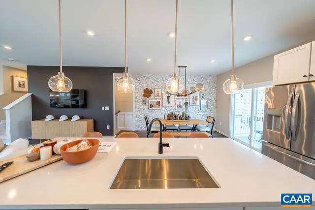 a kitchen with counter top space and living room view