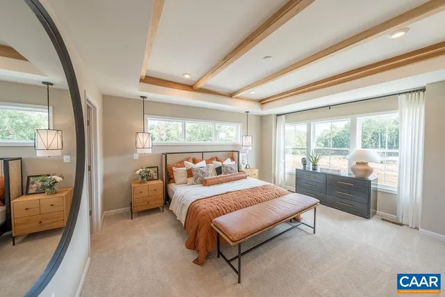 a bedroom with a bed and large window