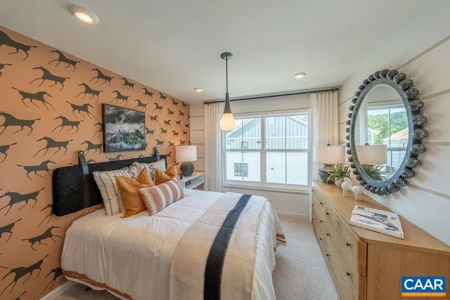 a bedroom with a bed and a large window