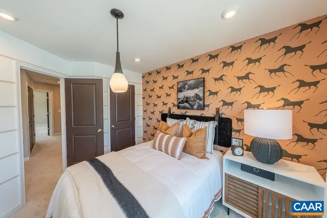 a bedroom with bed and wooden floor