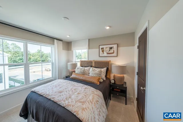 a bedroom with a large bed and a large window