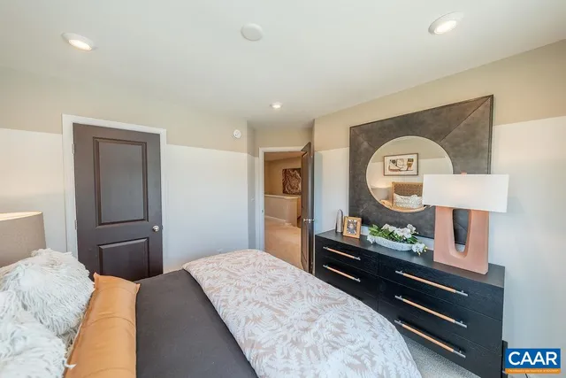 a bedroom with a bed and a dresser in it