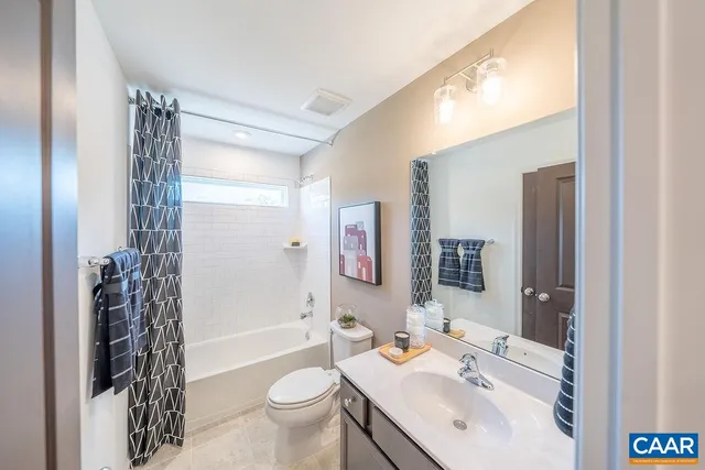 a bathroom with a sink toilet tub and shower