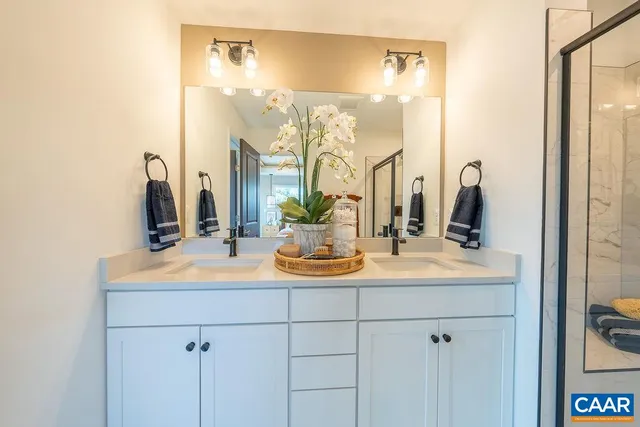 a bathroom with a double vanity sink and a mirror