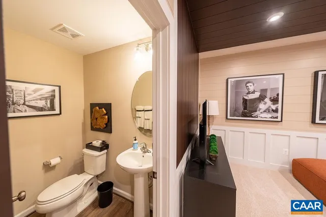 a bathroom with a toilet a sink and a mirror