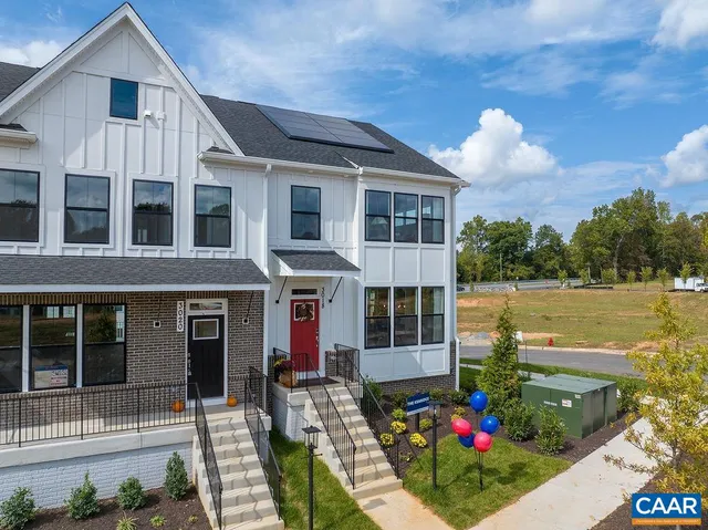 a view of a house with sitting area and garden
