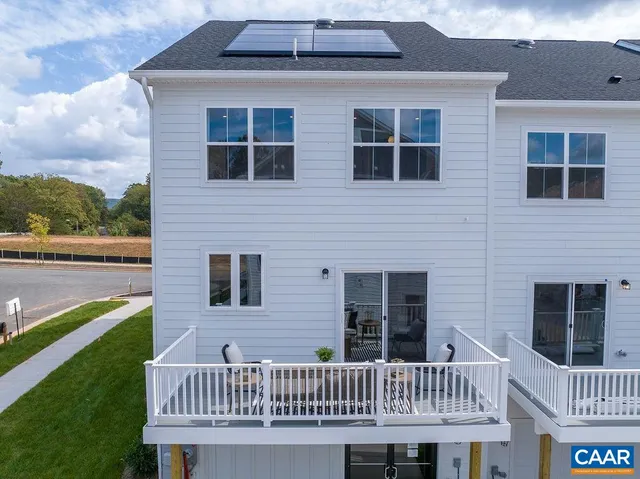 a view of a brick house with a yard