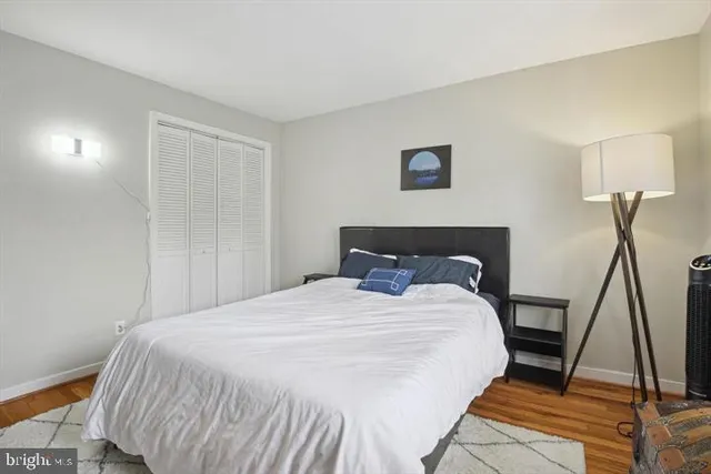 a large bed sitting in a bedroom next to a lamp