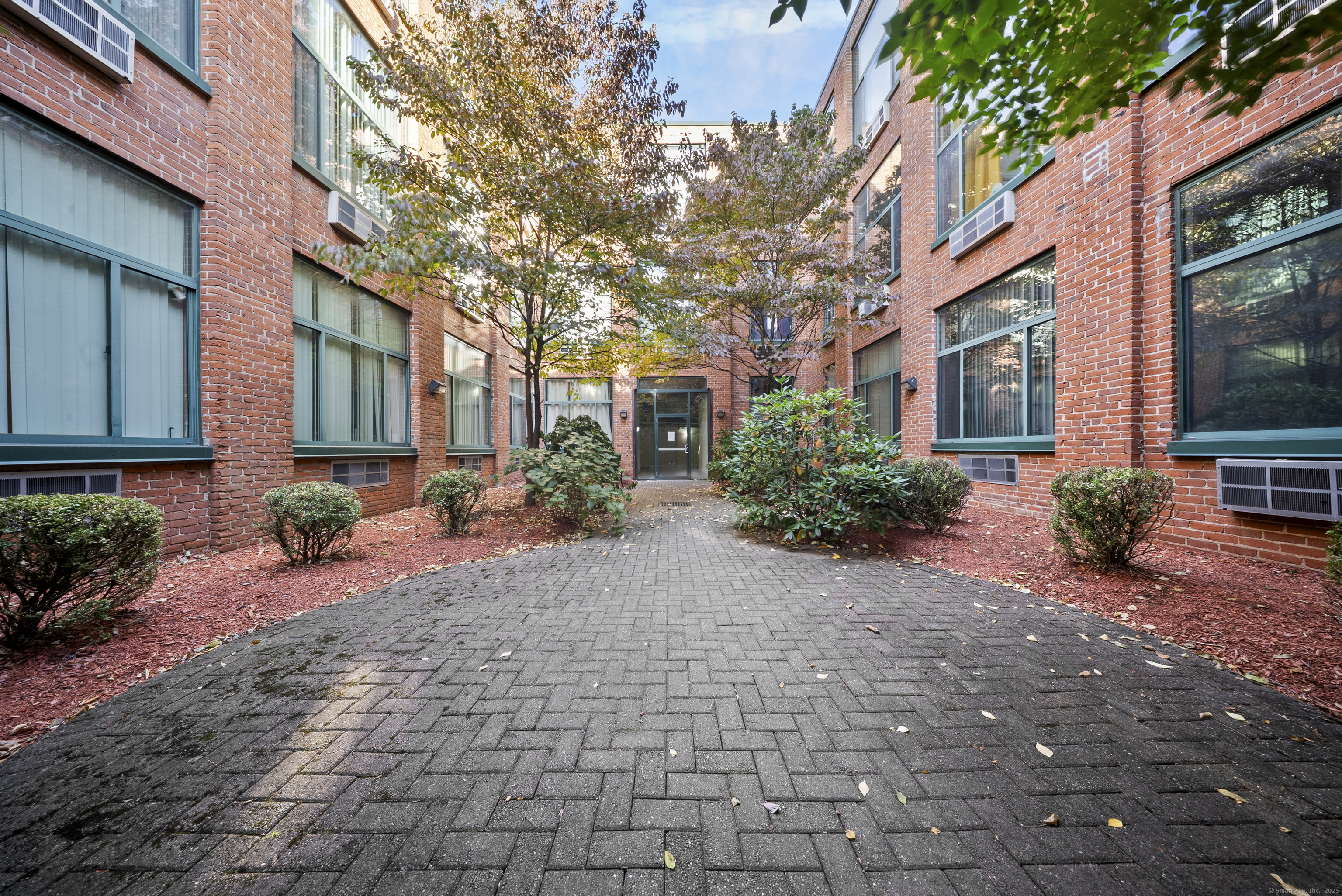 a view of a brick house with a yard