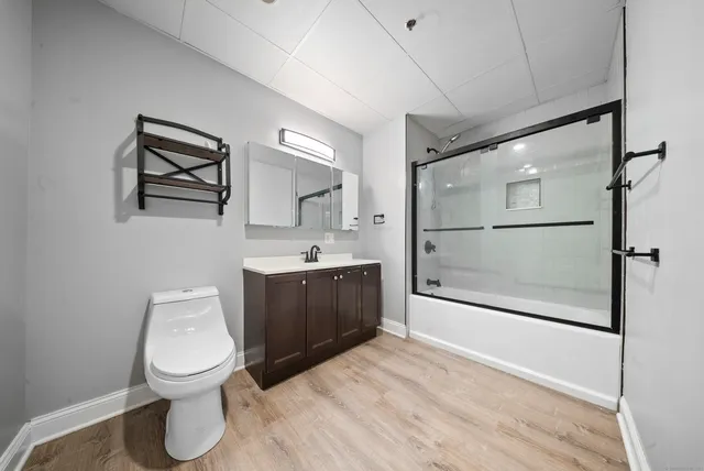 a bathroom with a toilet a sink and mirror