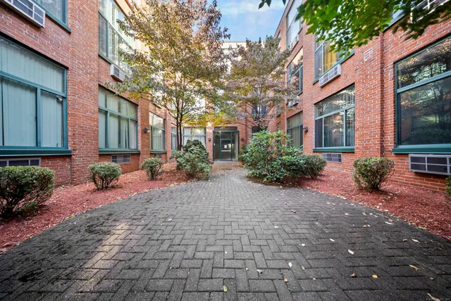 a view of a brick house with a yard