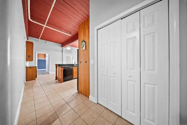 a view of a hallway with wooden cabinets