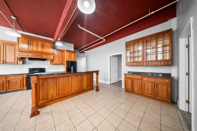 a kitchen with granite countertop a sink and cabinets