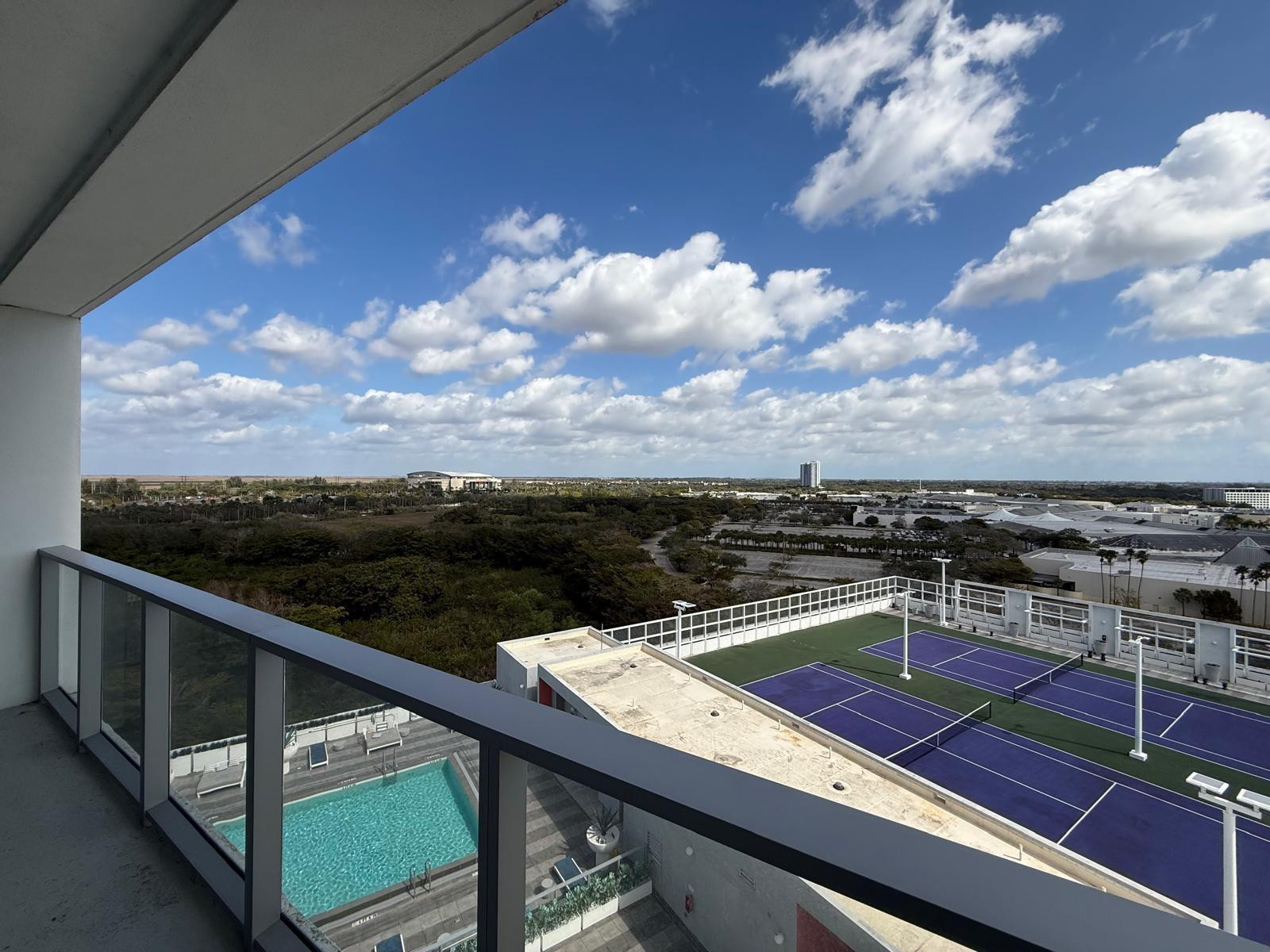 2000 Metropica Way, Unit 1109 Sunrise, FL 33323 - Photo 15 of 34 a view of a balcony with wooden floor and city view