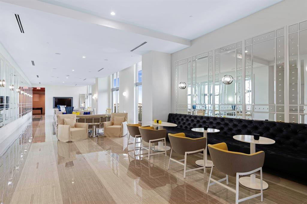 2000 Metropica Way, Unit 1109 Sunrise, FL 33323 - Photo 24 of 34 a dining hall with couches a coffee table and chairs