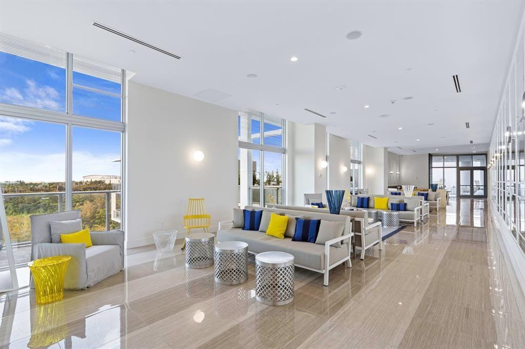 2000 Metropica Way, Unit 1109 Sunrise, FL 33323 - Photo 26 of 34 a living room with furniture and a dining table with wooden floor