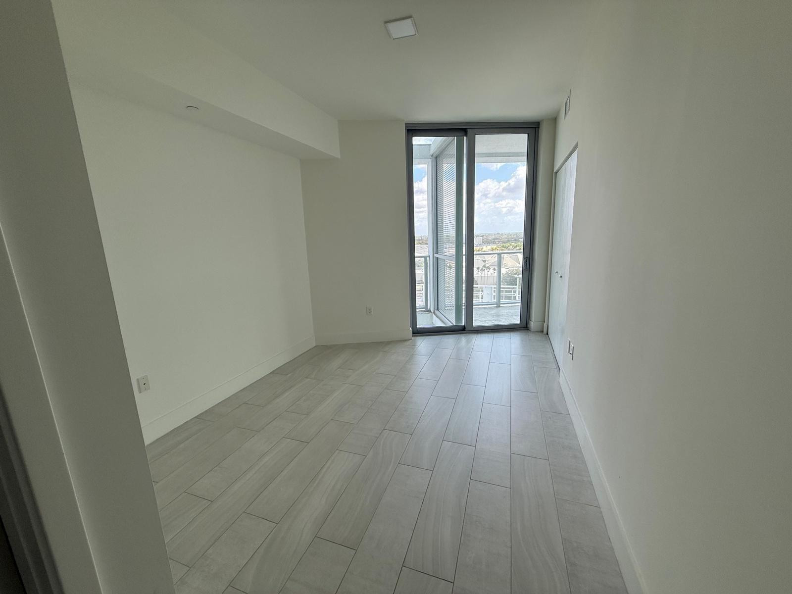 2000 Metropica Way, Unit 1109 Sunrise, FL 33323 - Photo 3 of 34 an empty room with wooden floor and windows