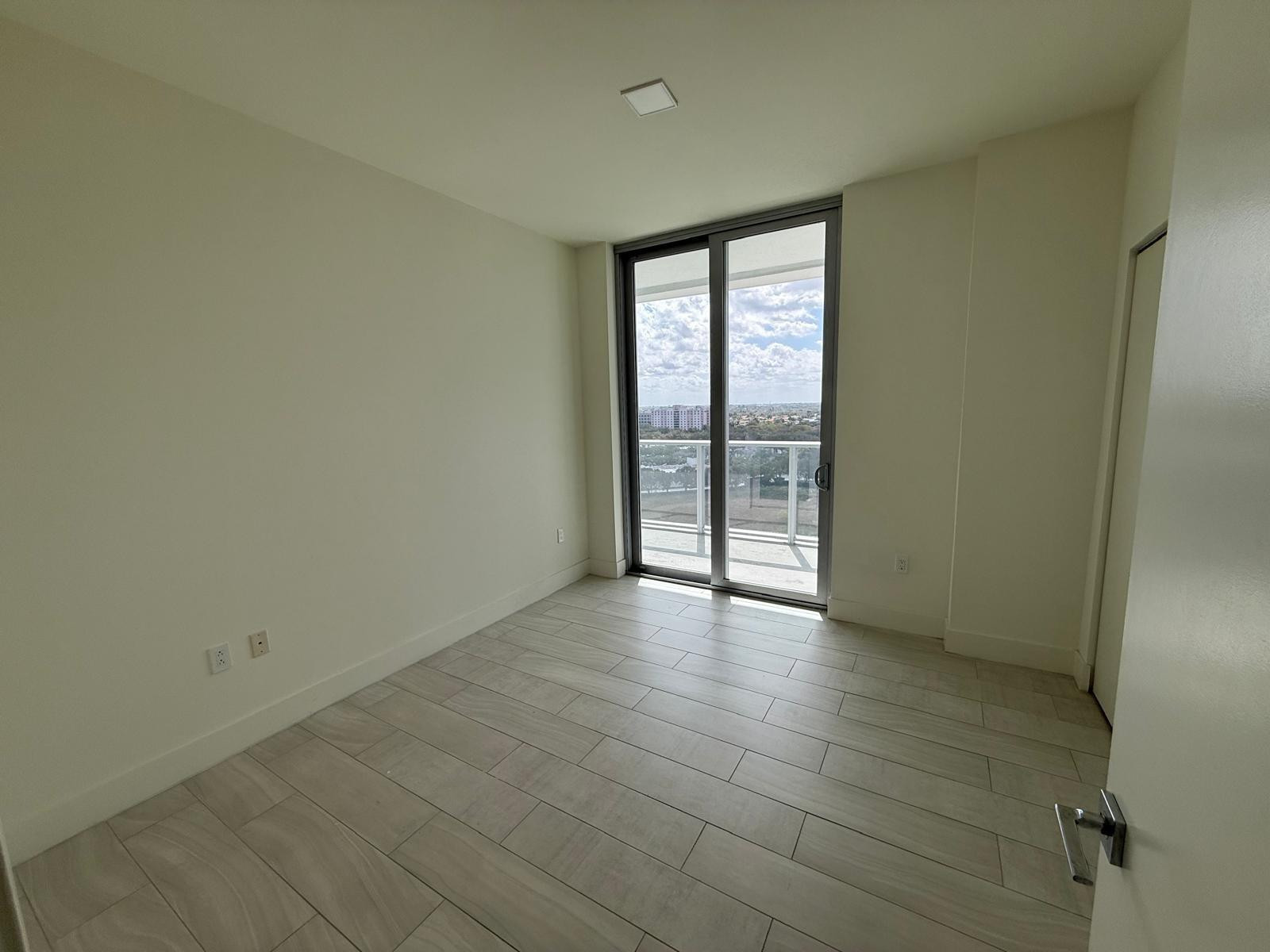 2000 Metropica Way, Unit 1109 Sunrise, FL 33323 - Photo 7 of 34 wooden floor in an empty room with a window