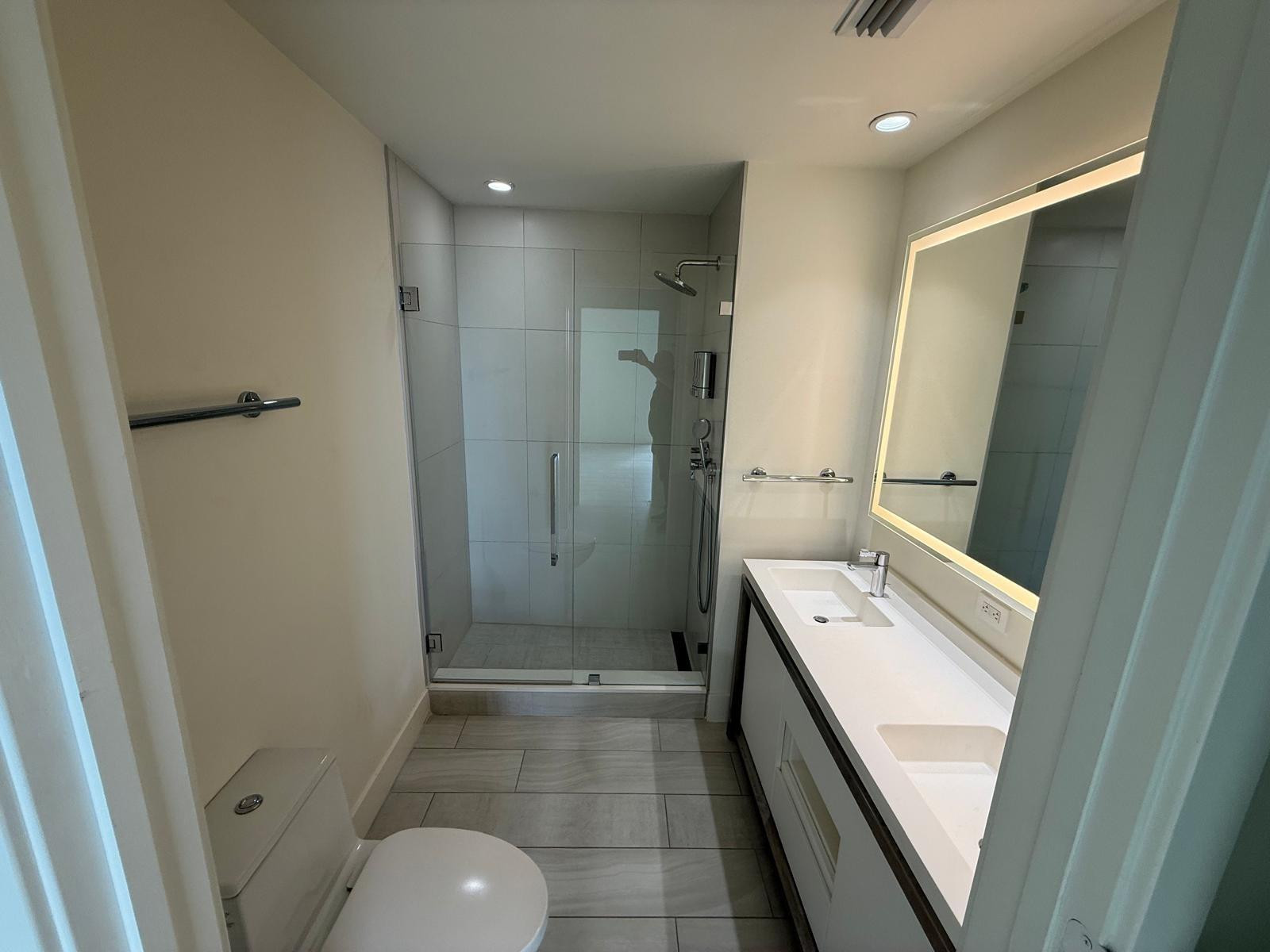 2000 Metropica Way, Unit 1109 Sunrise, FL 33323 - Photo 9 of 34 a bathroom with a sink a toilet and shower
