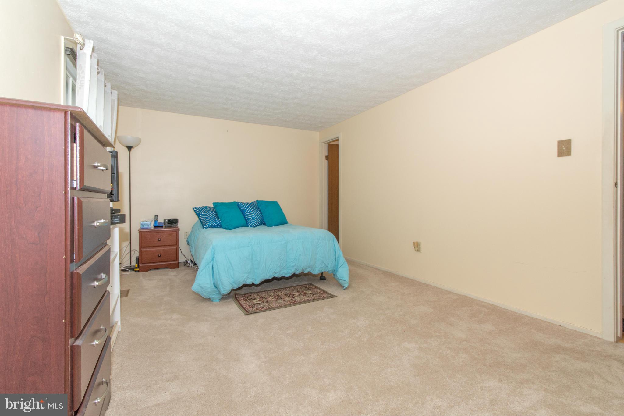 4825 Hawksbury Road Baltimore, MD 21208 - Photo 13 of 29 a bedroom with a bed and a cabinets