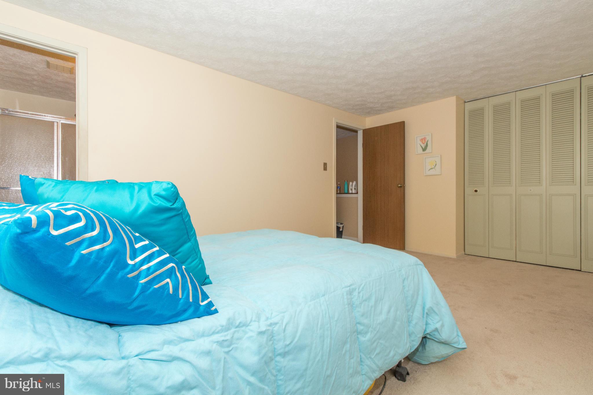 4825 Hawksbury Road Baltimore, MD 21208 - Photo 14 of 29 a bedroom with a bed and a mirror