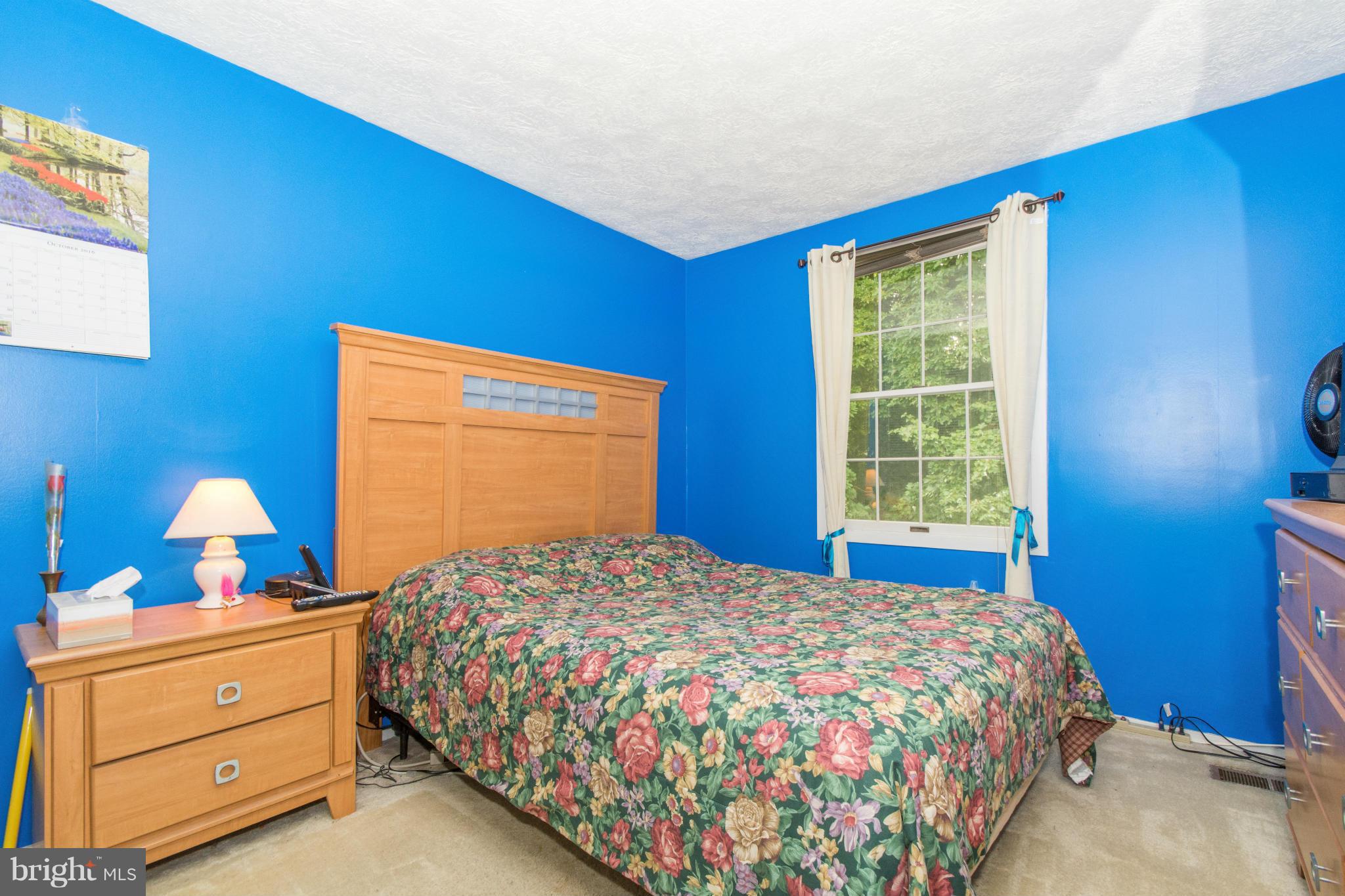 4825 Hawksbury Road Baltimore, MD 21208 - Photo 18 of 29 a bedroom with a bed and window