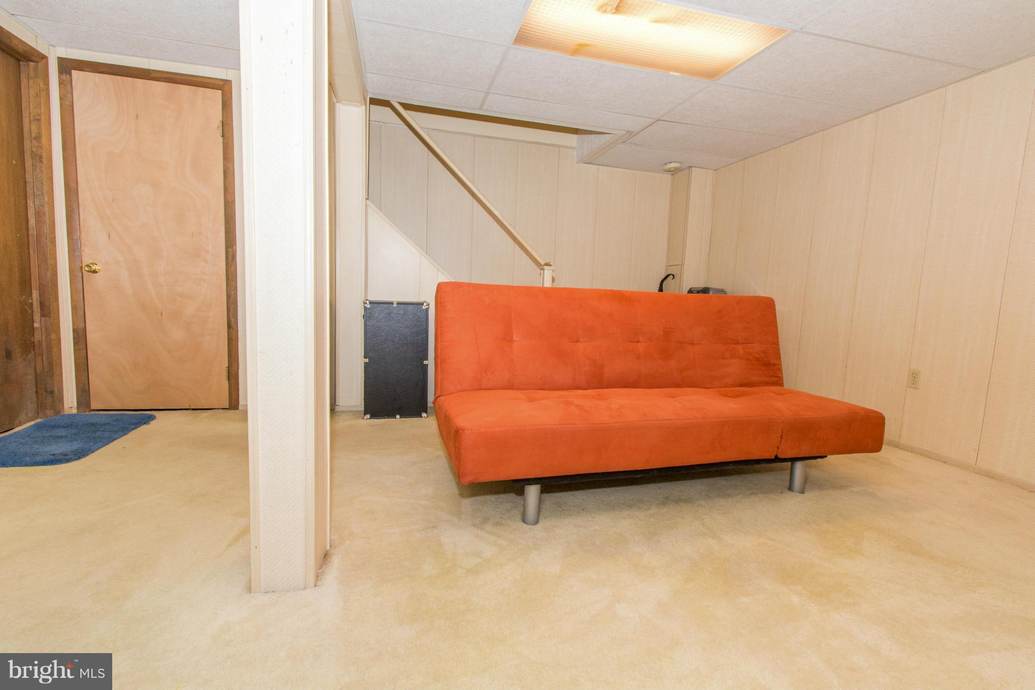 4825 Hawksbury Road Baltimore, MD 21208 - Photo 21 of 29 a blue bed sitting in a room next to a window