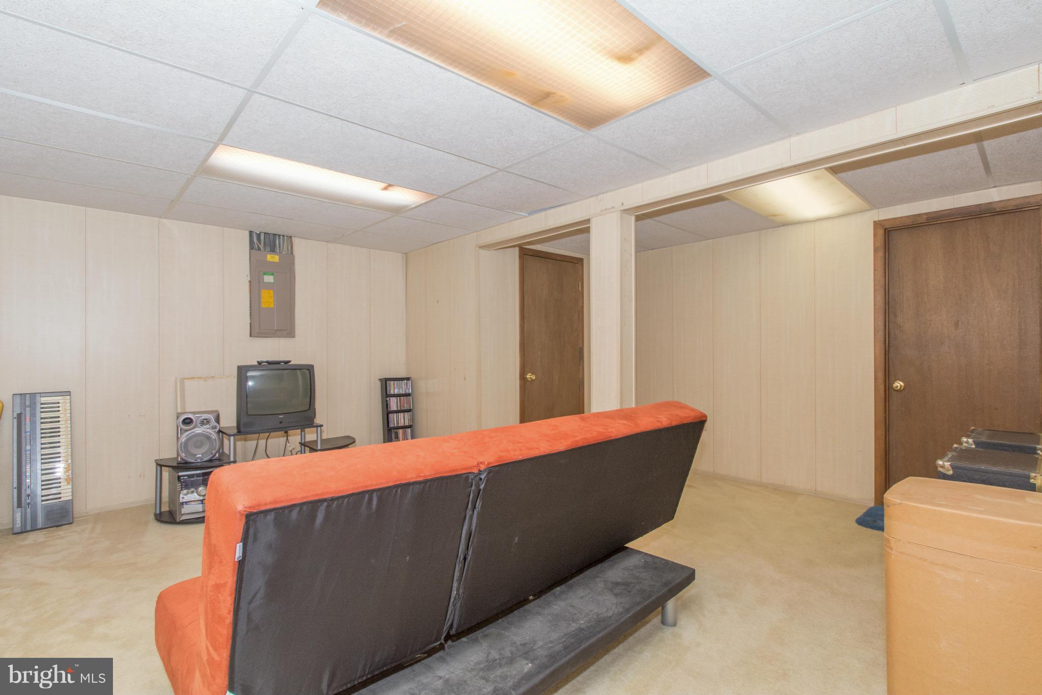 4825 Hawksbury Road Baltimore, MD 21208 - Photo 22 of 29 a living room with furniture and a flat screen tv