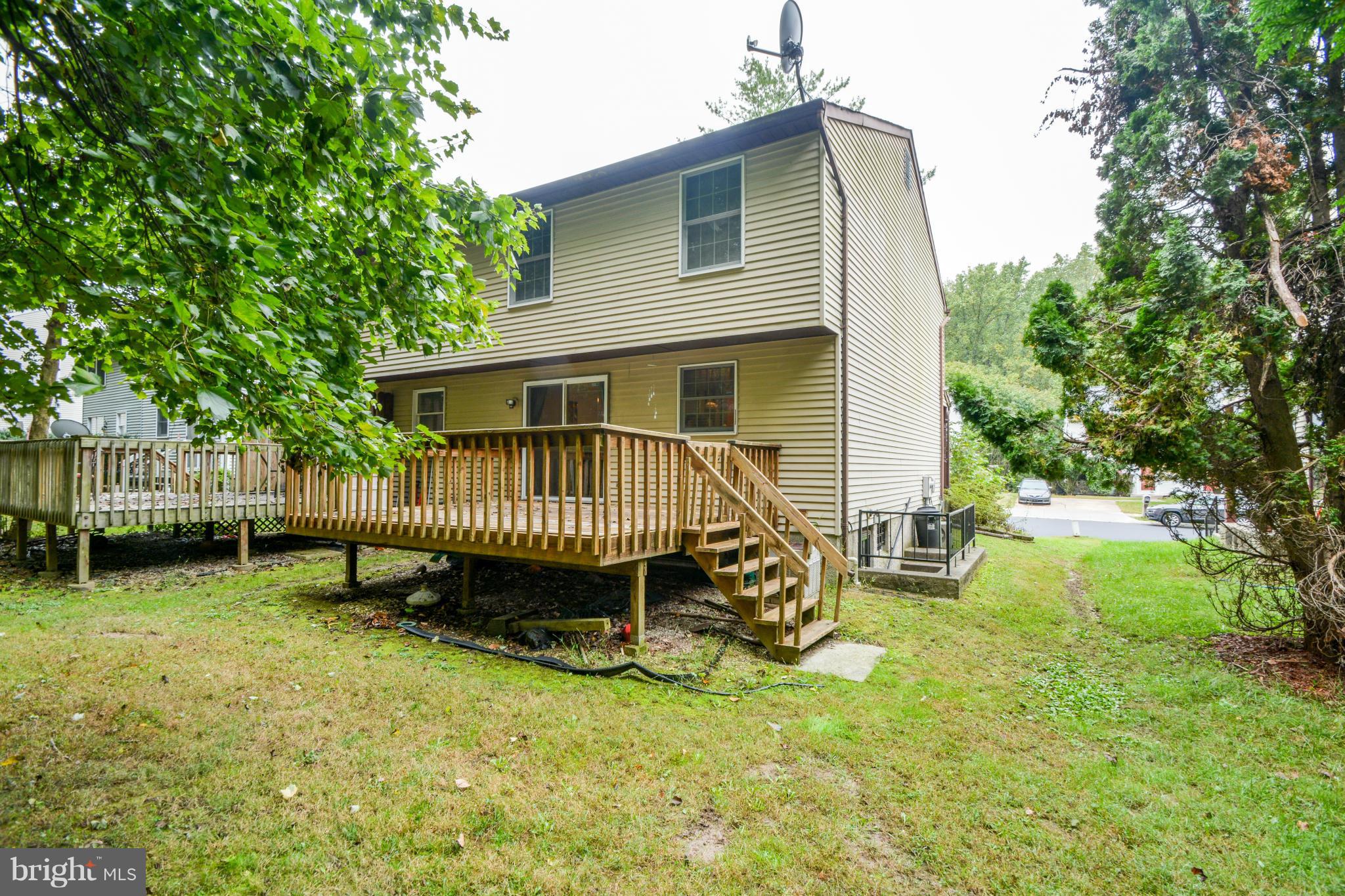 4825 Hawksbury Road Baltimore, MD 21208 - Photo 26 of 29 a view of a house with a backyard and a patio