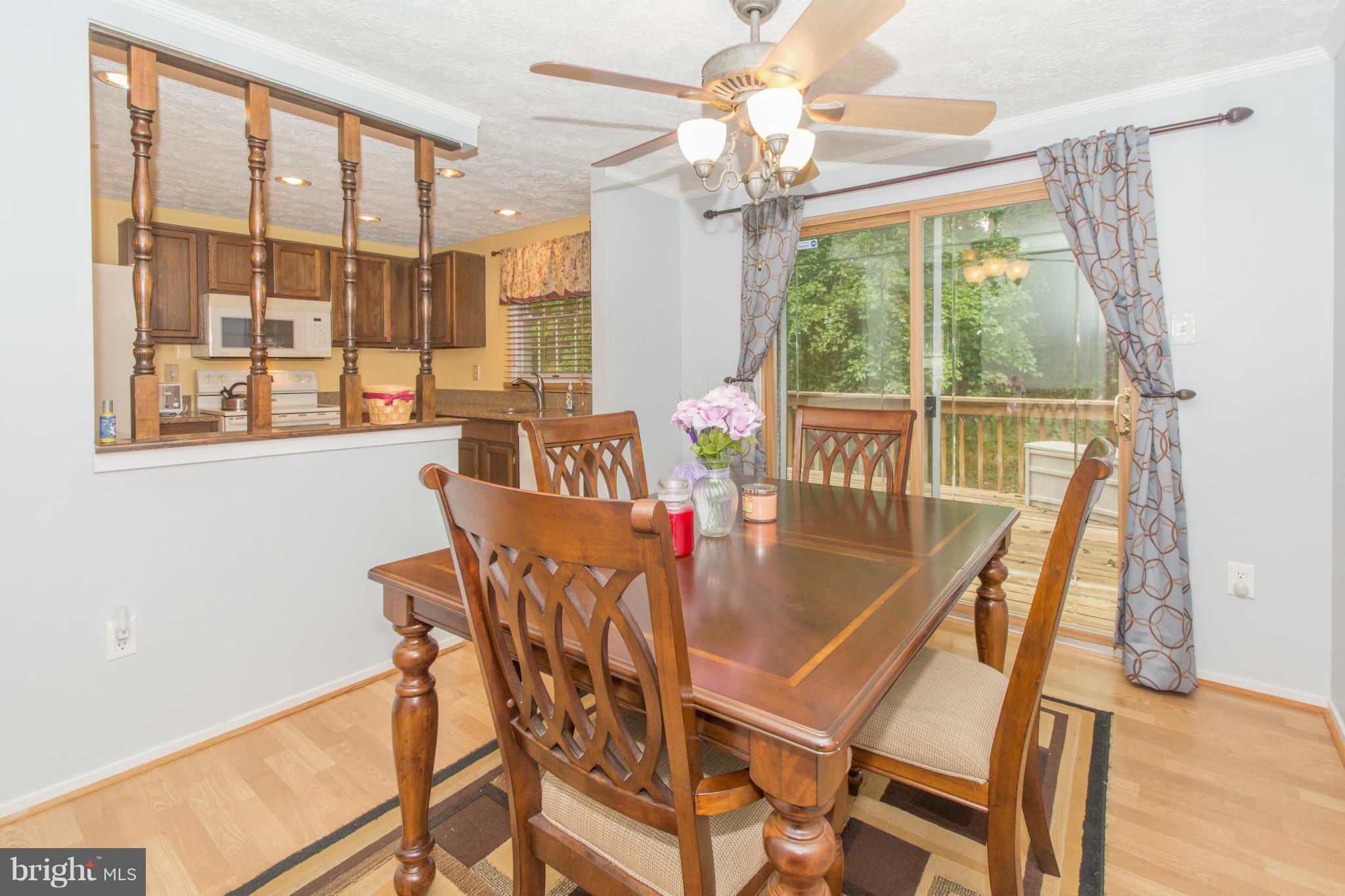 4825 Hawksbury Road Baltimore, MD 21208 - Photo 5 of 29 a dining room with furniture a chandelier and wooden floor