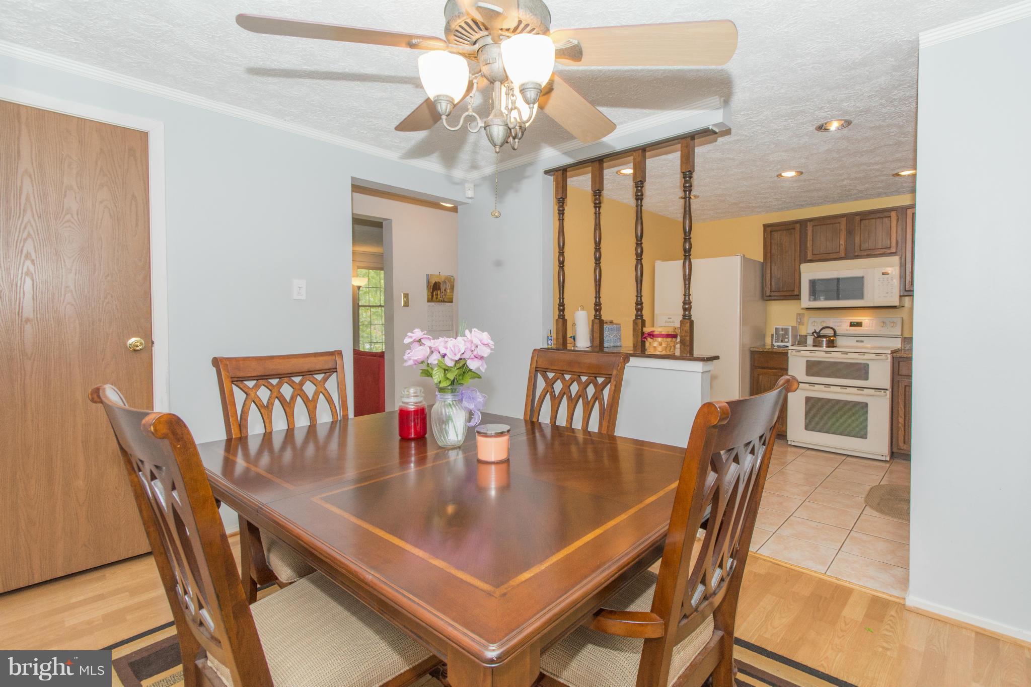 4825 Hawksbury Road Baltimore, MD 21208 - Photo 6 of 29 a view of a dining room with furniture and a chandelier
