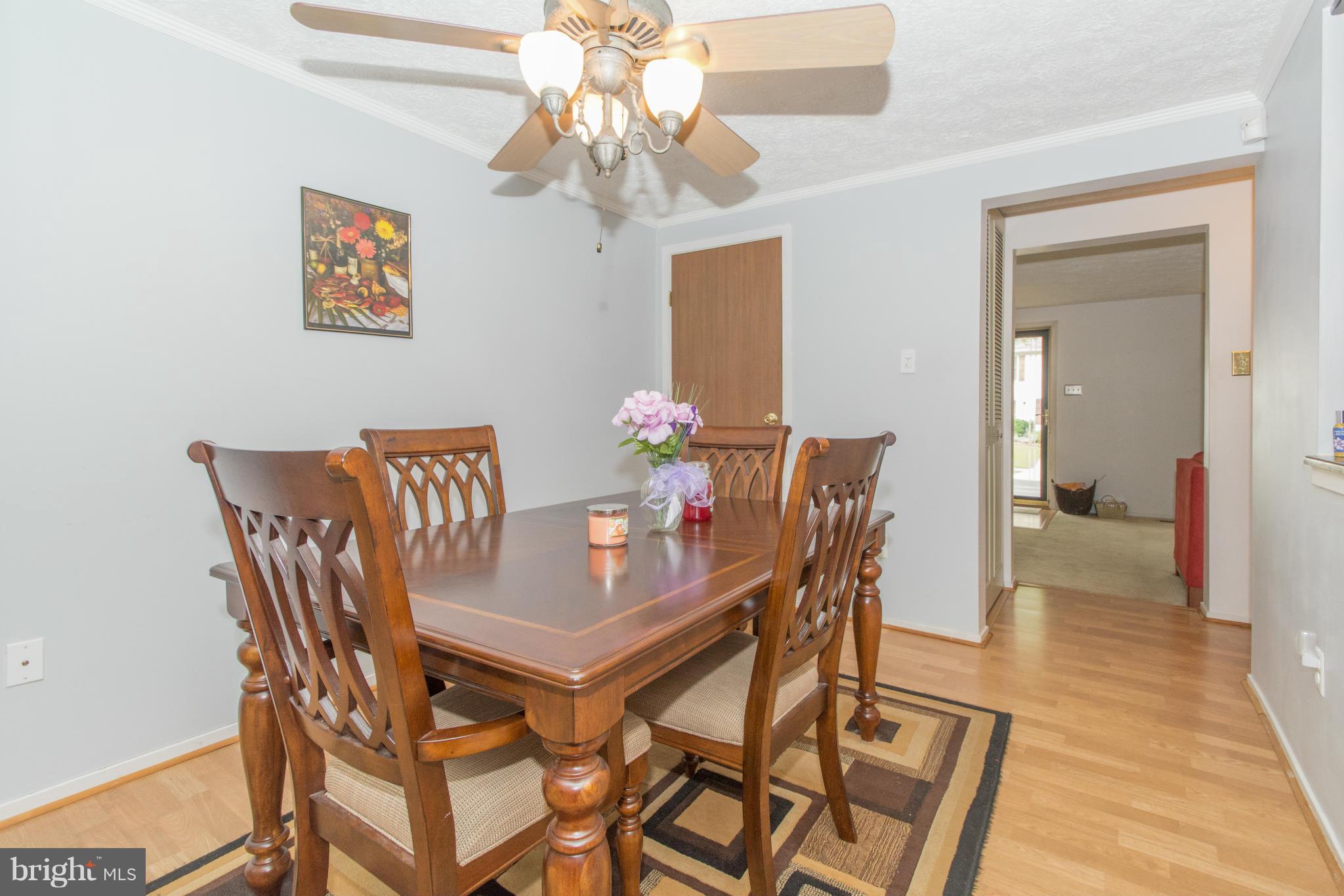 4825 Hawksbury Road Baltimore, MD 21208 - Photo 7 of 29 a view of a dining room with furniture and wooden floor