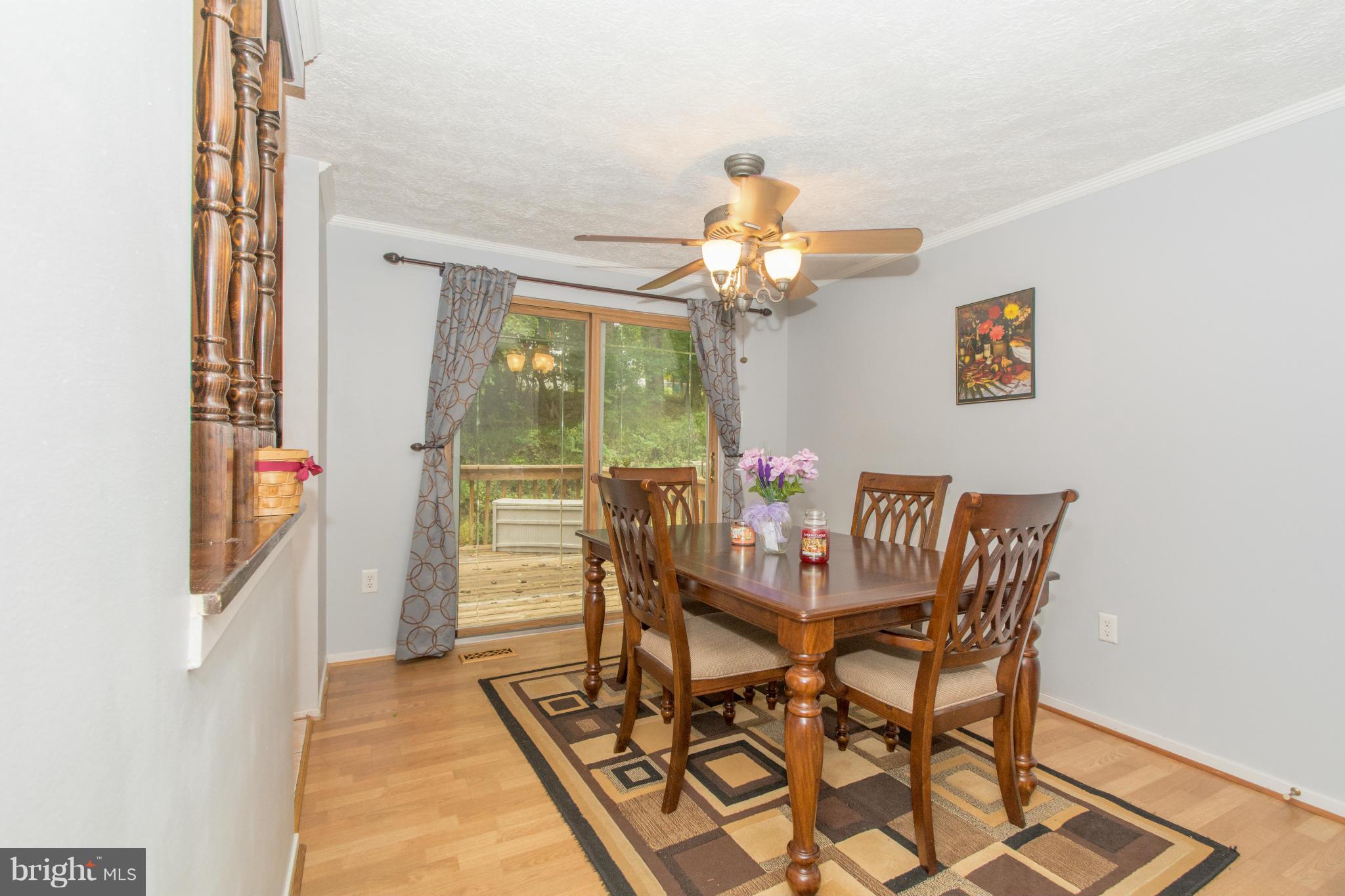 4825 Hawksbury Road Baltimore, MD 21208 - Photo 8 of 29 a view of a dining room with furniture and chandelier