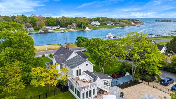 an aerial view of a house with a garden and lake view