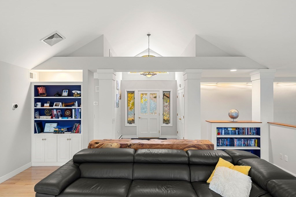 7 Par Brae Grantham, NH 03753 - Photo 16 of 42 a living room with a couch and a bookshelf