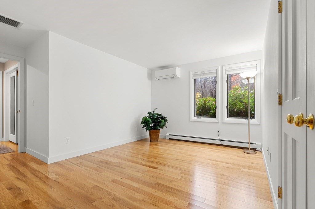 7 Par Brae Grantham, NH 03753 - Photo 19 of 42 a view of an empty room with wooden floor and a window