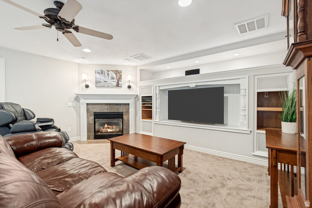 1567 Ridgeview Circle Farmington, UT 84025 - Photo 44 of 55 Built-in entertainment center, recessed lighting, ceiling fan, fireplace with tile surround, and built-in shelving