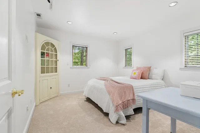 a spacious bedroom with a bed and a window