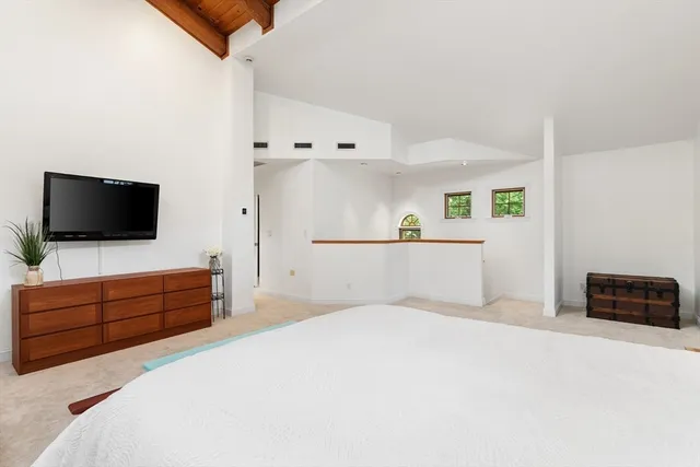 a bedroom with a bed and flat screen tv