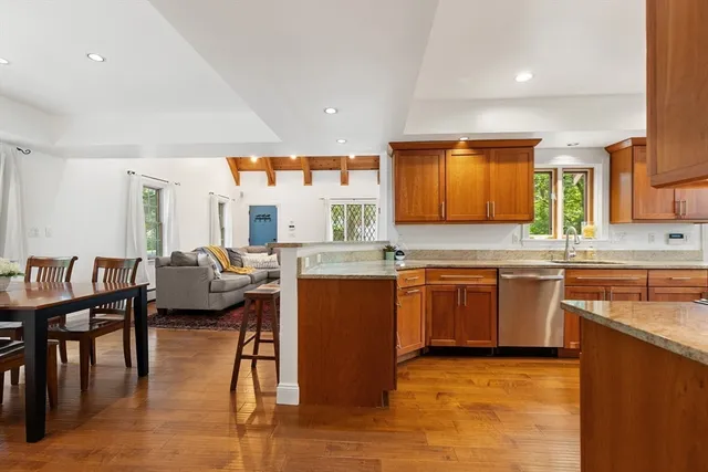 a kitchen with stainless steel appliances granite countertop sink stove top oven and cabinets