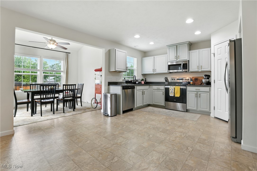 2112 Fowl Road Elyria, OH 44035 - Photo 13 of 49 Kitchen with stainless steel appliances, a ceiling fan, dark countertops, recessed lighting, and gray cabinets